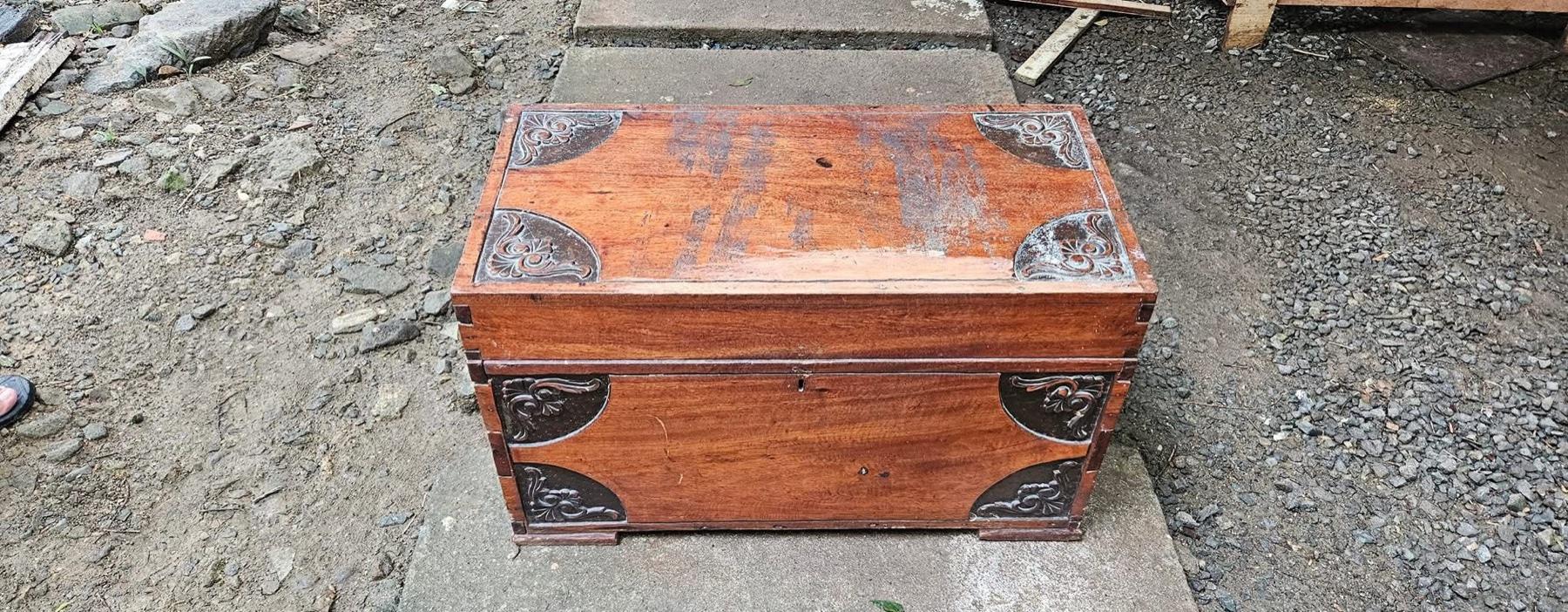 An antique wood chest before restoration.