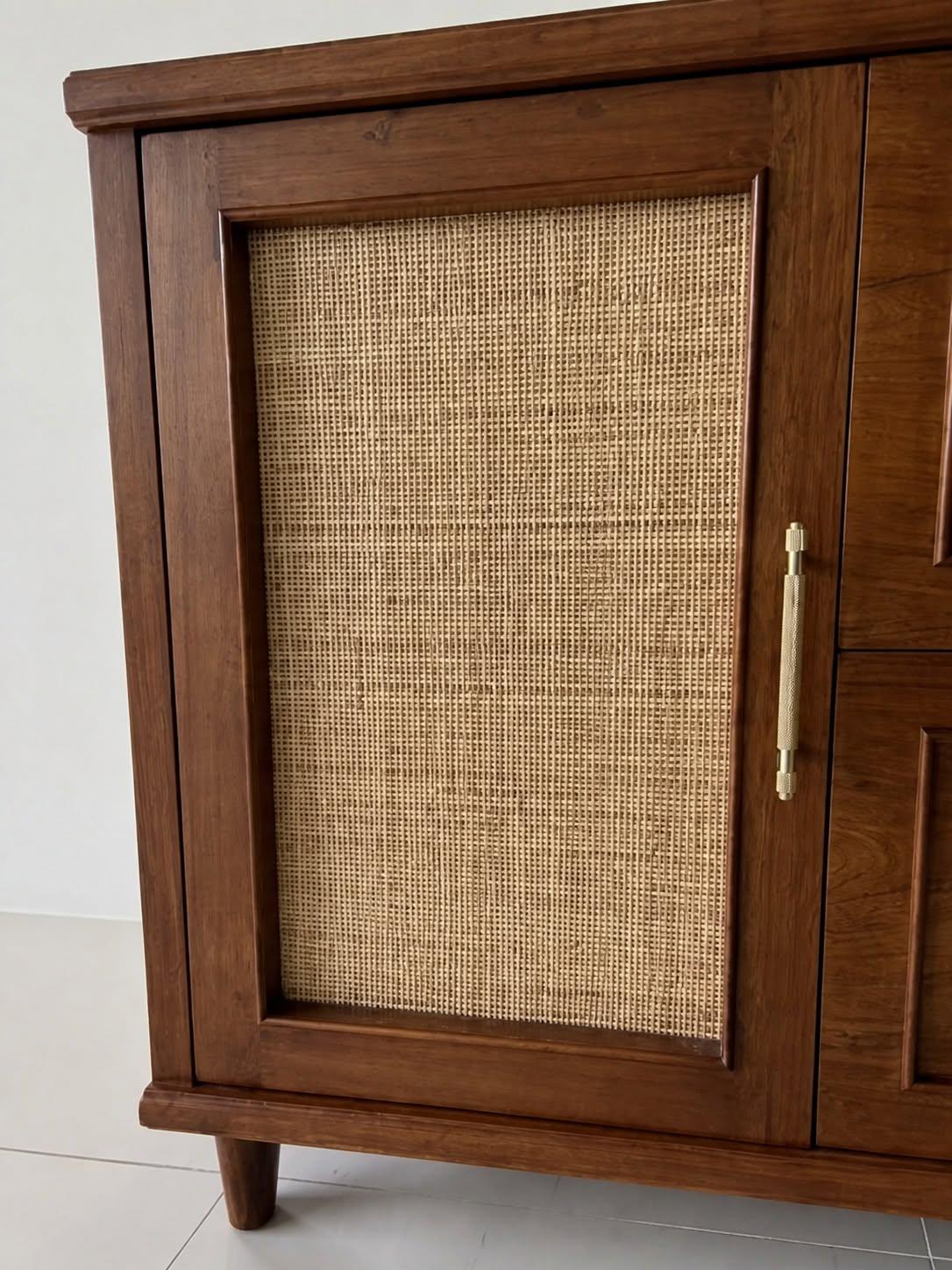Close-up of the cabinet’s woven cane panel and wood frame.