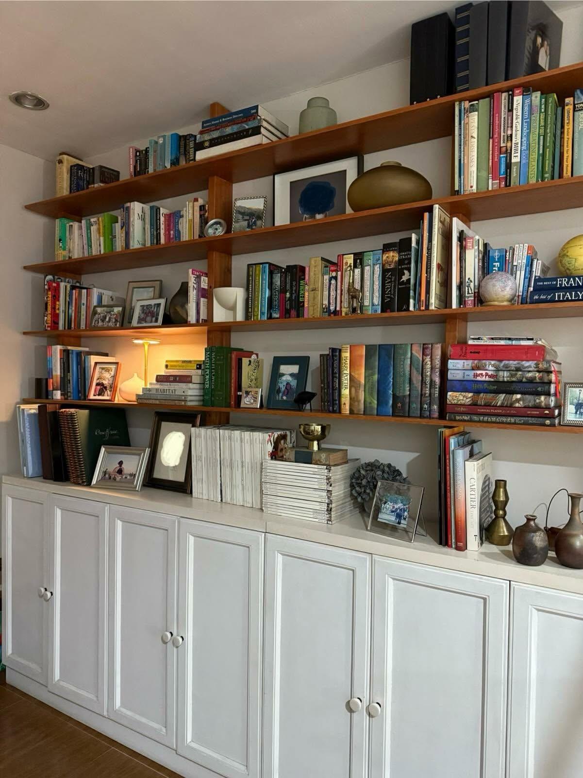 Wood library shelving with white lower cupboards