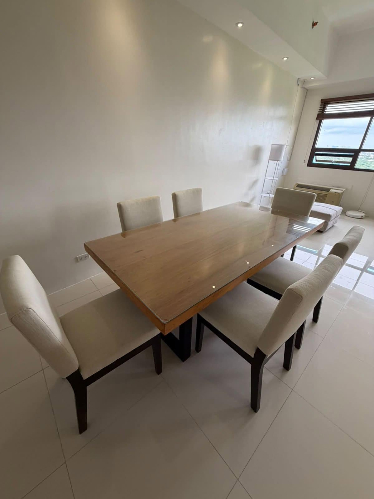 Narra dining table with six cream upholstered chairs
