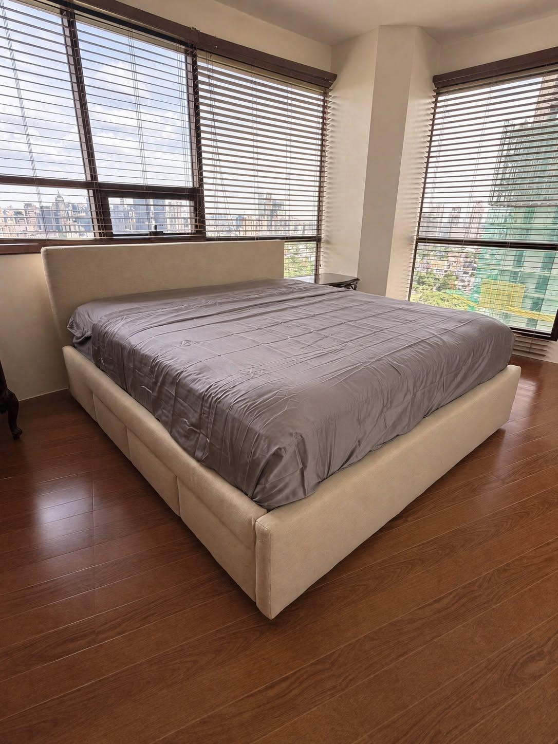 Beige upholstered bed and headboard